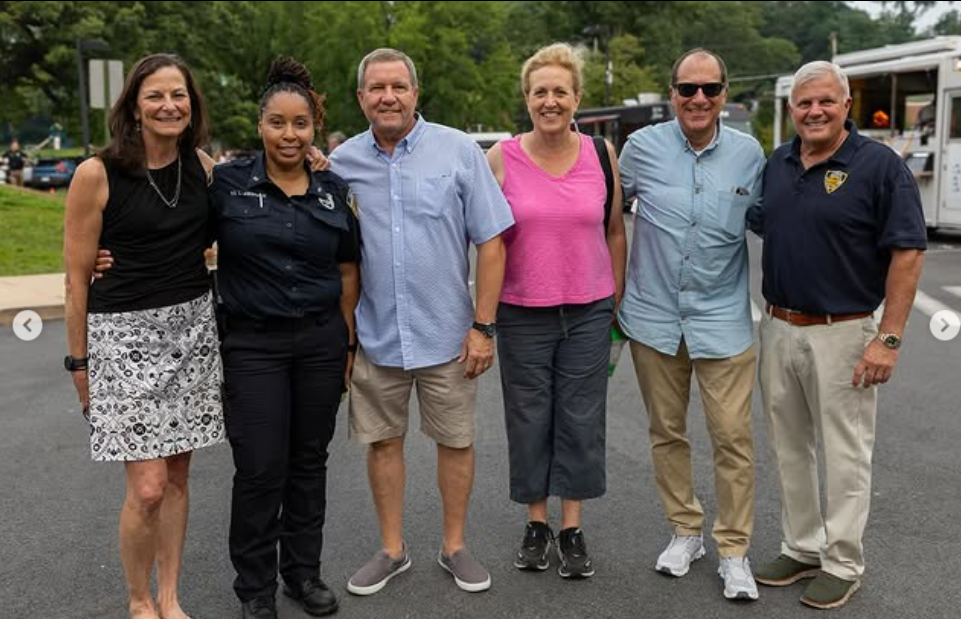 (PHOTO: City of Rye Police Advisory Board members and officials Chair Lisa Dominici, P.O. Latoya Anderson, Bart DiNardo, Councilmember Jamie Jensen, Mayor Josh Nathan and Public Safety Commissioner Mike Kopy at the 2025 National Night Out at Rye Recreation on August 5. Contributed.)