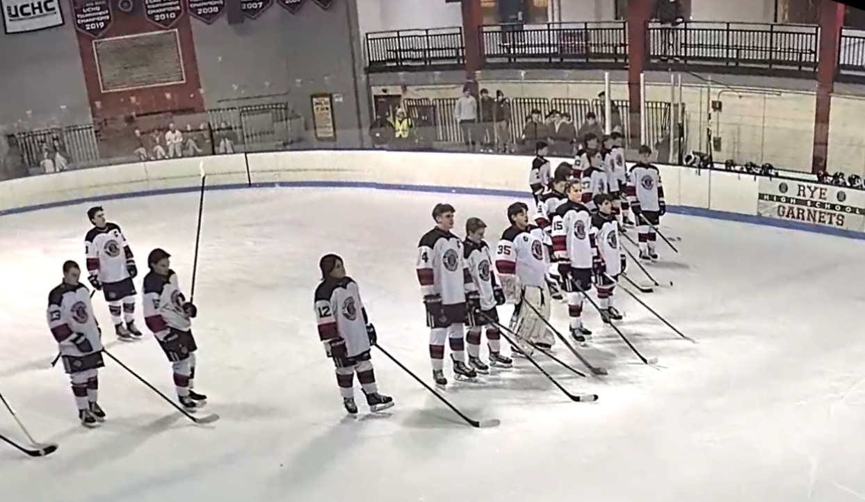 (PHOTO: The Rye Hockey team lined up for the anthem before a game vs Suffern on February 4, 2026.)