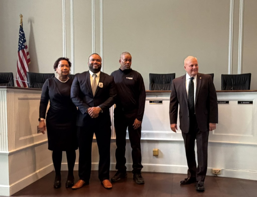(PHOTO: Police Officer Craig Dorn Jr. (center left) with with his mother Allison Bush, Dorn, his father Craig Dorn Sr. and Public Safety Commissioner Mike Kopy at Dorn's swearing in at Rye City Hall on March 2, 2026.)