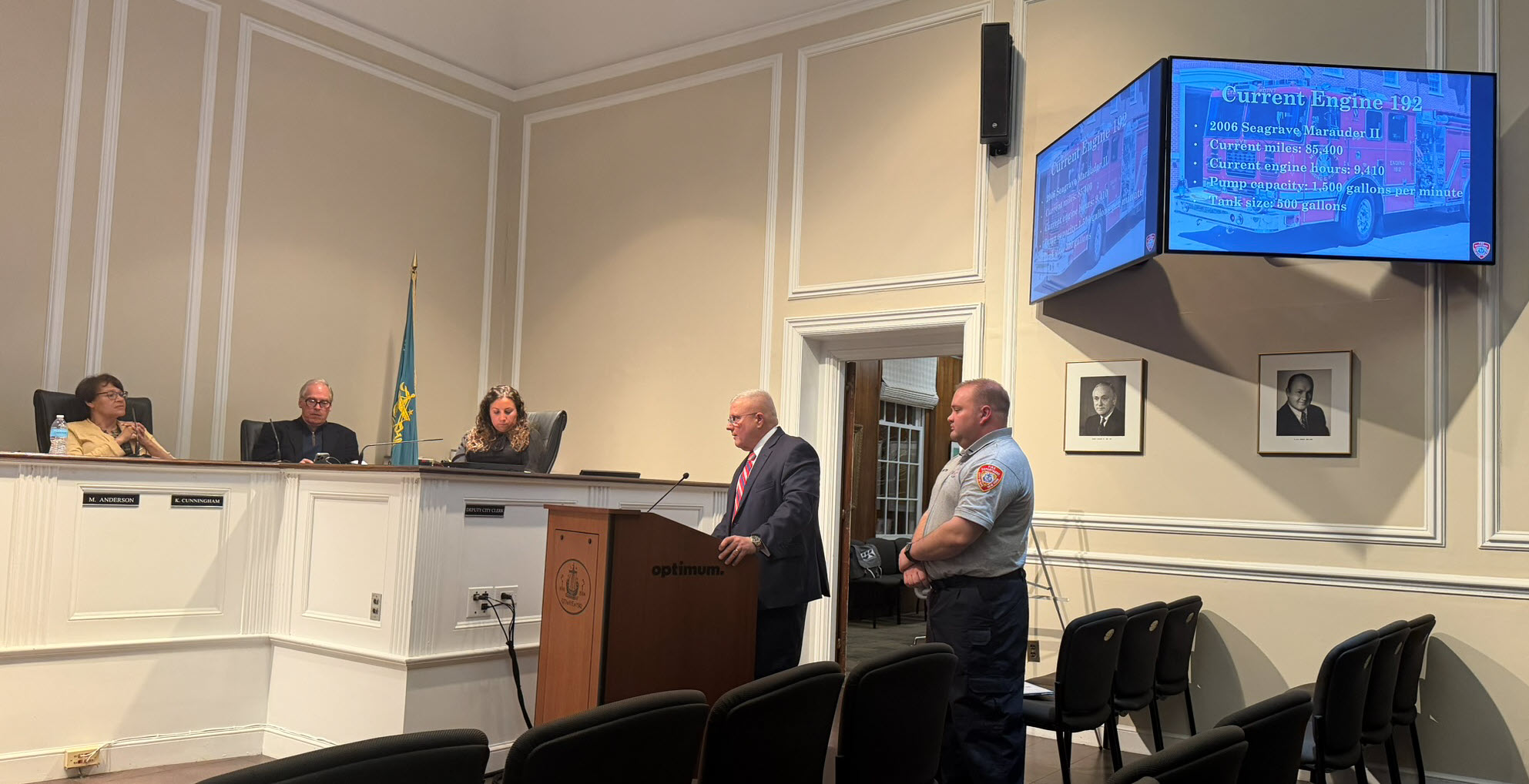 (PHOTO: Public Safety Commissioner Mike Kopy and Rye FD Lieutenant Max Billington discuss the City's newly improved ISO rating at the Rye City Council on March 4, 2026.)