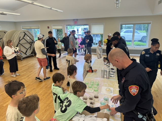 (PHOTO: Rye Youth Soccer wraps up the 2025 season with ice cream sponsored by the Police Advisory Committee. Contributed.)