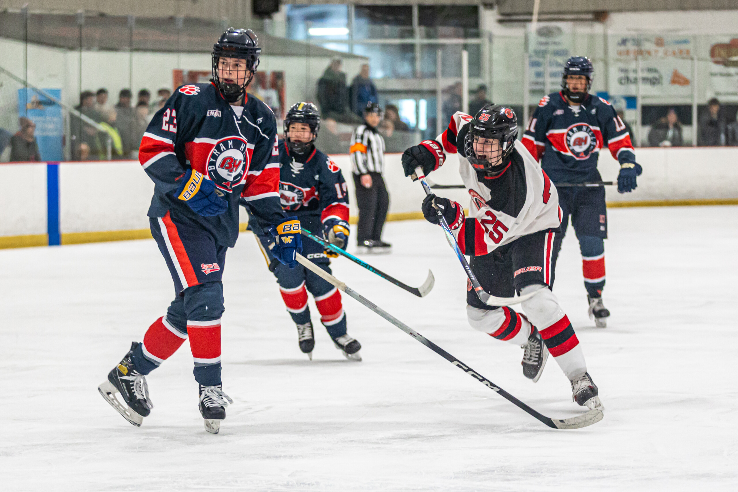 (PHOTO: Rye Hockey's Jack McGill (#25 white) from March 1, 2026. Credit: Maureen Tsuchida.)