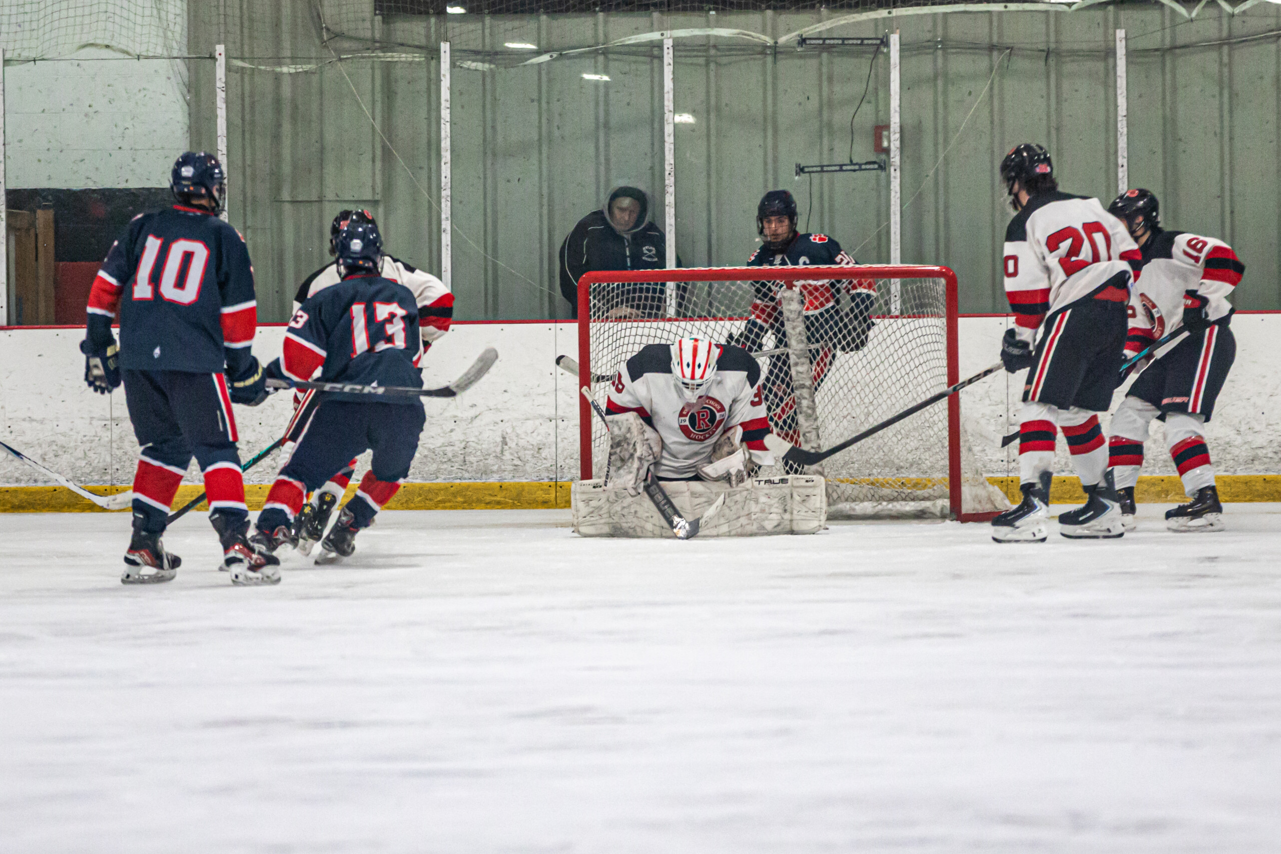 (PHOTO: Rye Hockey goalie Fernando Mosquera making a save on March 1, 2026. Credit: Maureen Tsuchida.)