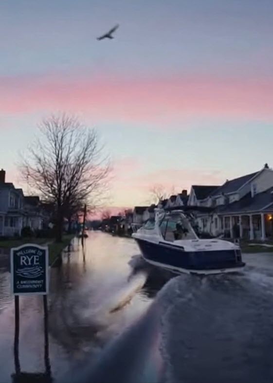 (PHOTO: To combat flooding, the new Rye Aquatic Resilience & Biodiversity Preservation Ordinance (RARBPO) requires every single-family homeowner to purchase and maintain a watercraft of at least 30 feet in length—parked curbside and ready for immediate deployment. Credit: THE RYE ONION Fake News, Really Rye. A Satirical Series Presented by MyRye.com. Image created with AI.)