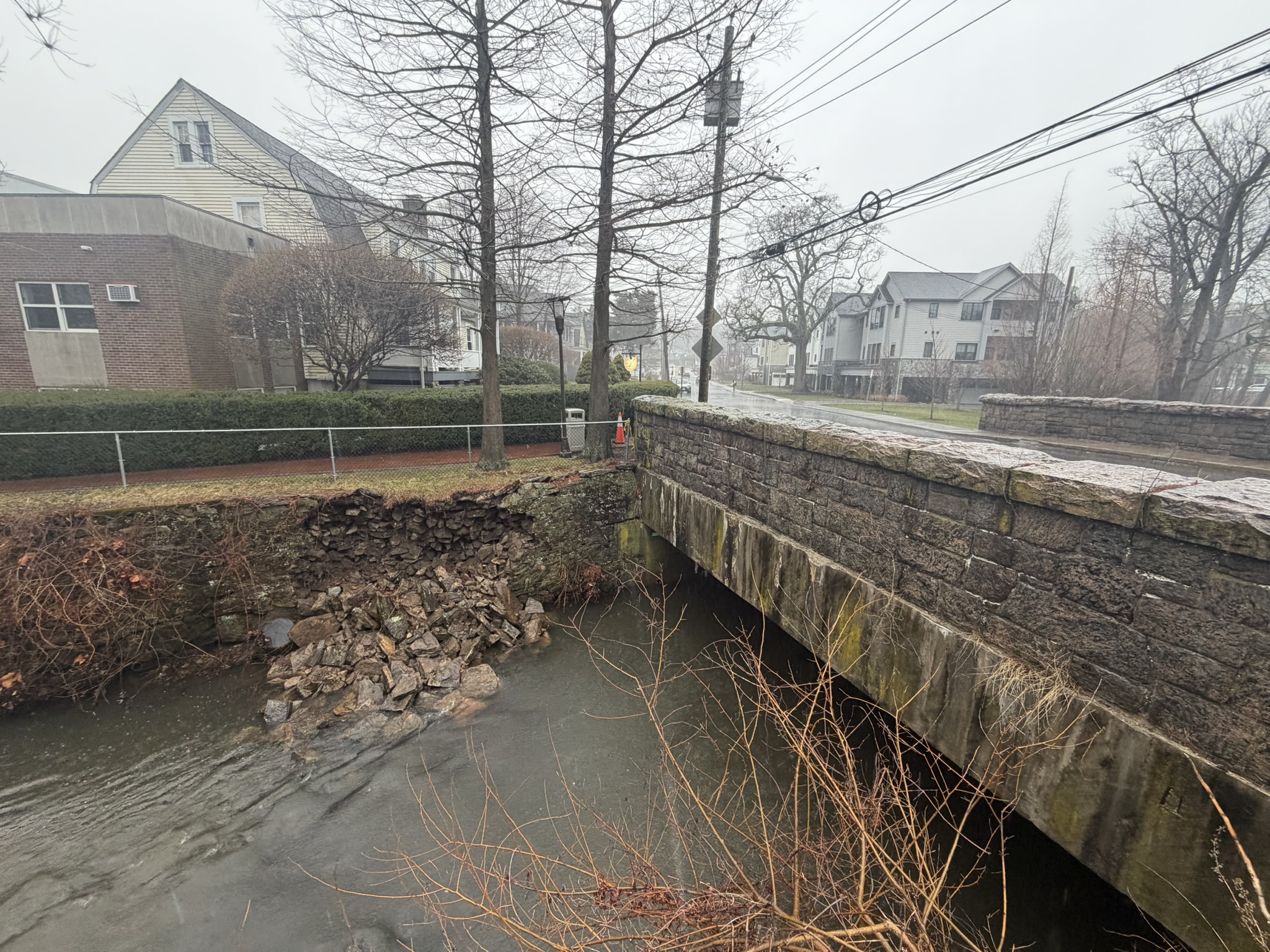 (PHOTO: The Blind Brook wall by the Rye YMCA and the Locust Avenue bridge collapsed into the brook on Thursday, March 12, 2026.)