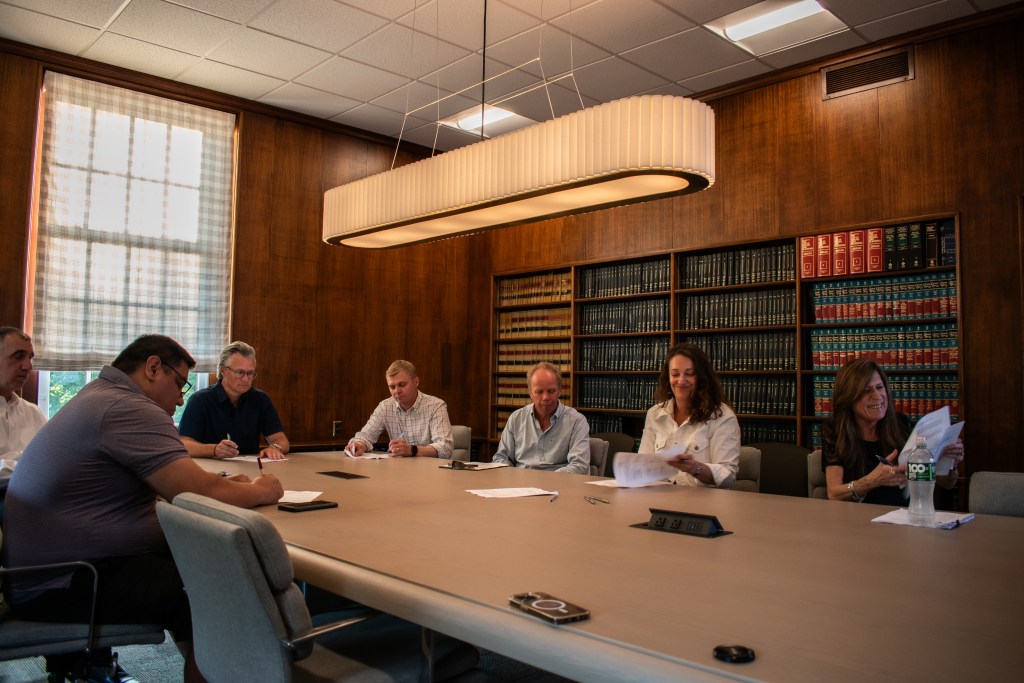 (PHOTO: A Board of Architectural Review meeting on June 17, 2024. Chair Michael Harrrington is at the head of the table in the black shirt. Credit: Tilman Oberbannscheidt.)