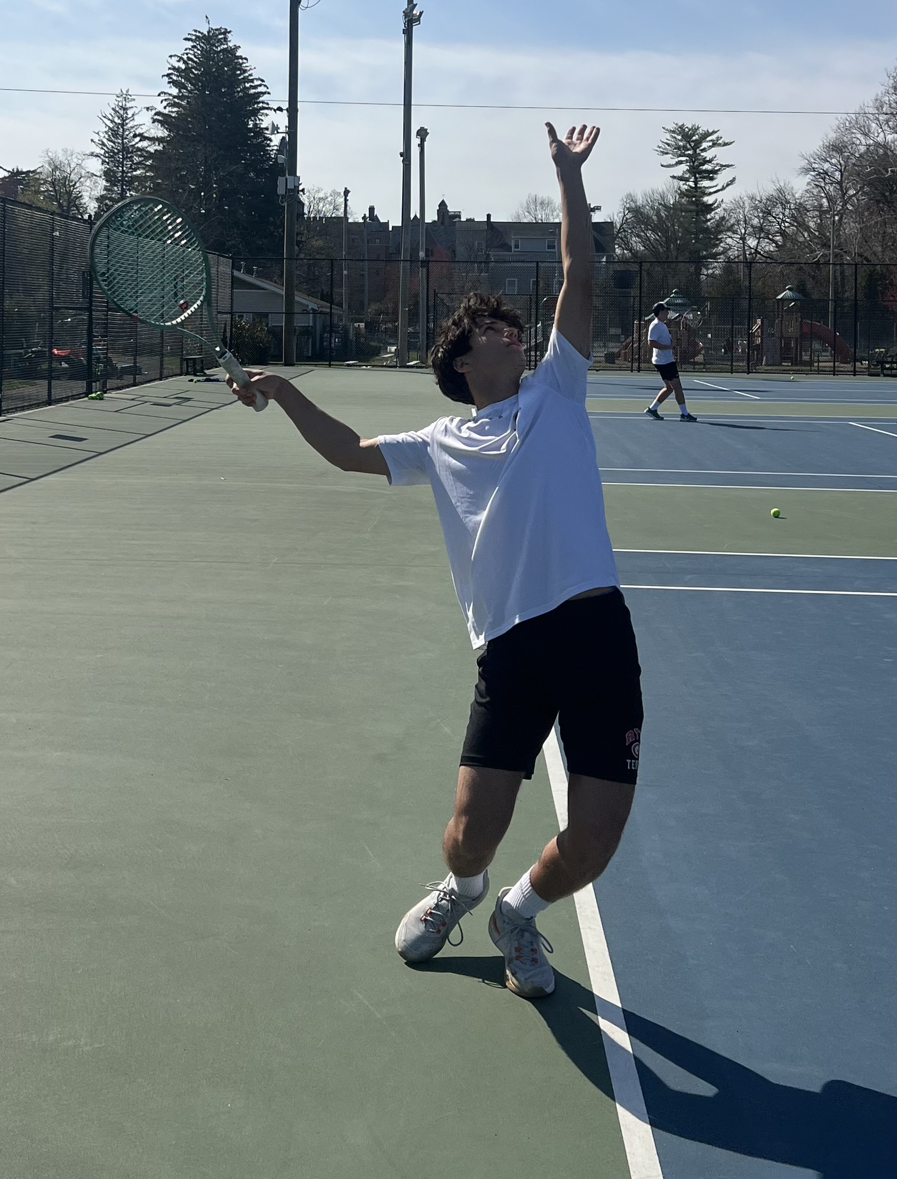 (PHOTO: Rye Boys Tennis' Marcos Becker serving against Scarsdale on April 16, 2026. Contributed.)