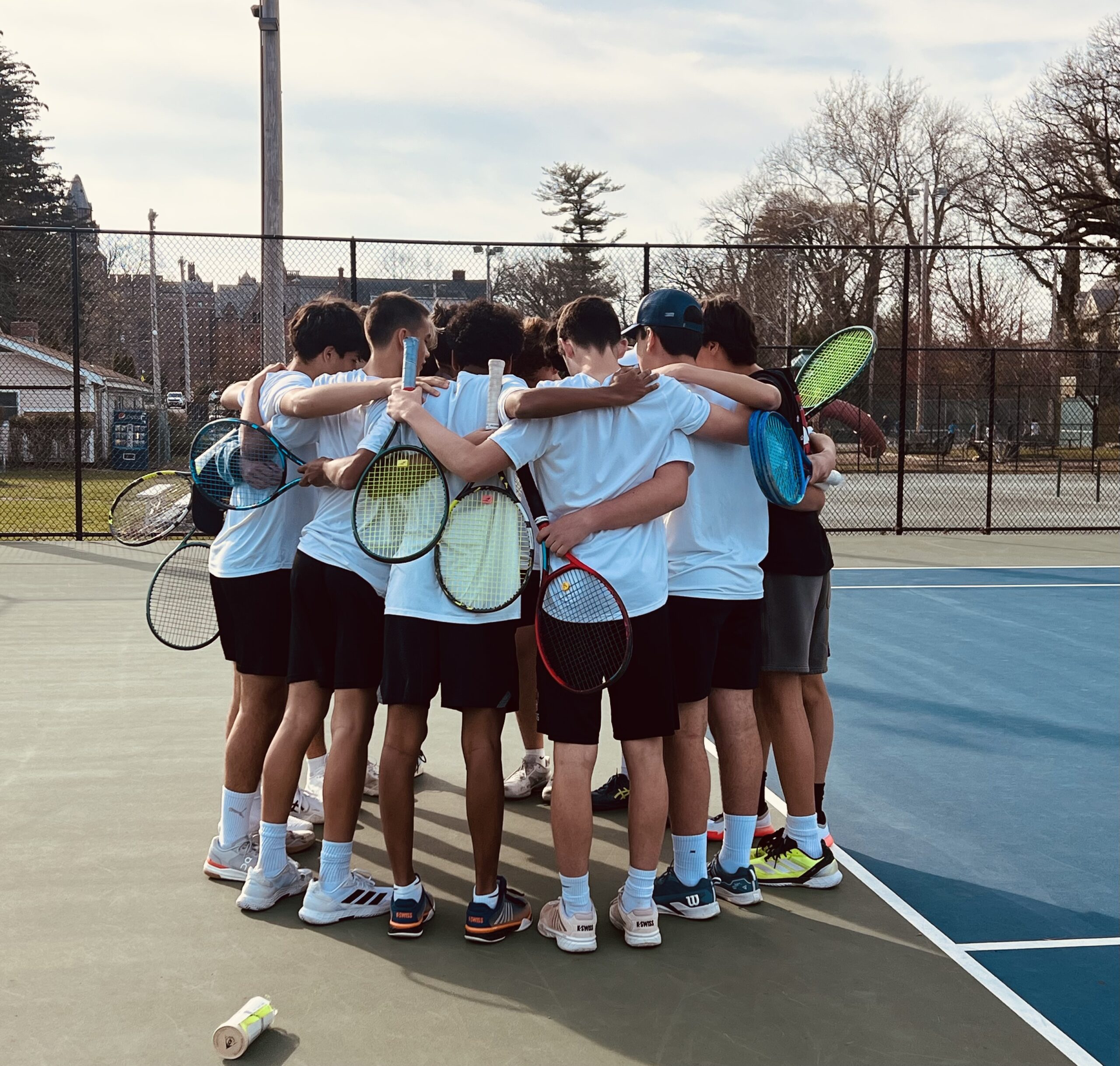 (PHOTO: The Rye Boys Tennis team in a pre-match huddle on April 10, 2026. Contributed.)