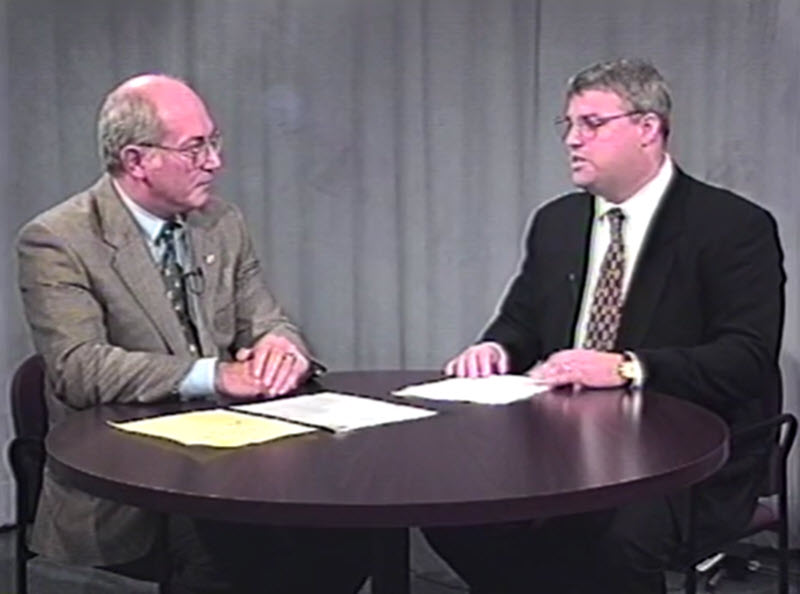 (PHOTO: Former City Councilmember James Burke (left) interviewing Chris Bradbury, assistant to the Rye City manager on Rye TV in 1997. Source: Rye TV.)