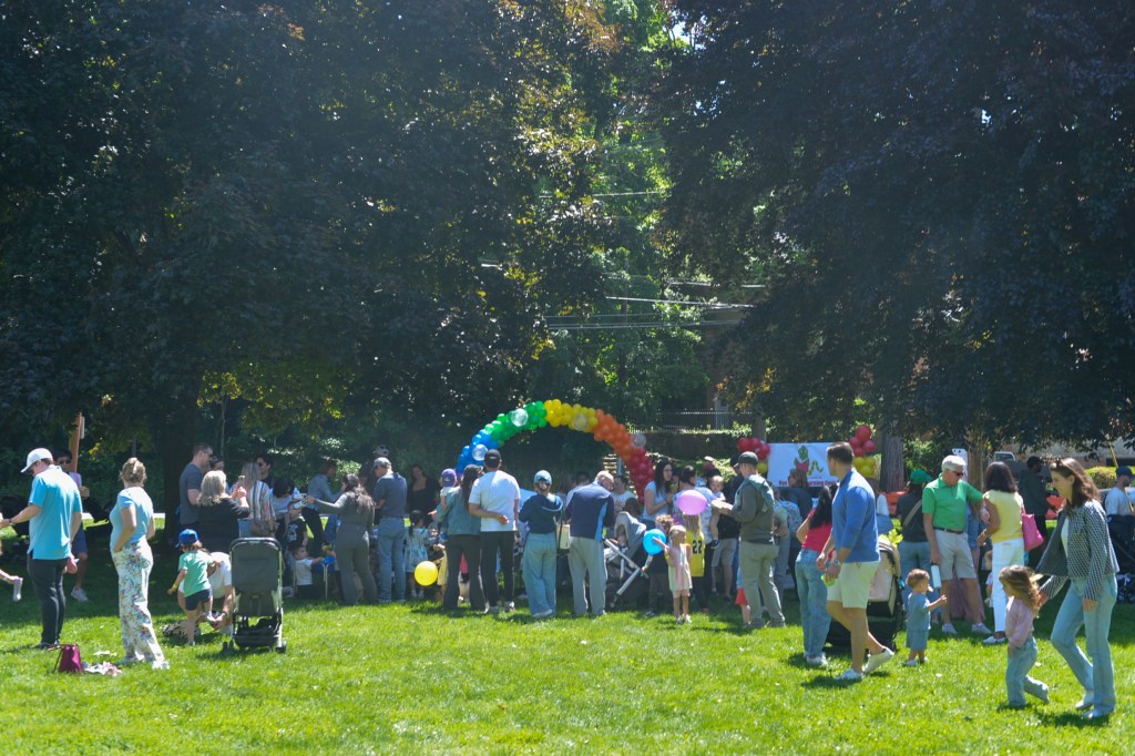 (PHOTO: Hundreds of children and families gathered on the Village Green for the Library's Vehicle Fair on May 31, 2026. Credit: Claire Hovers.)