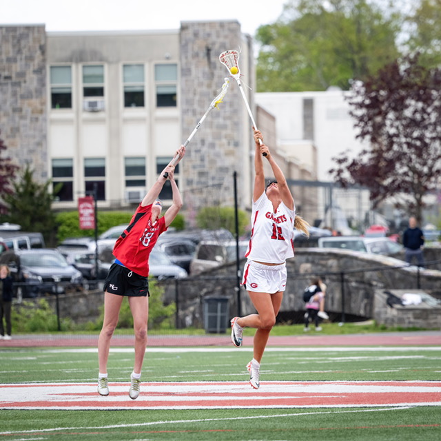 (PHOTO: Rye Girls Lacrosse's Beau Whaling (right) contesting the ball against a New Canaan defender from May 2, 2026. Contributed.)