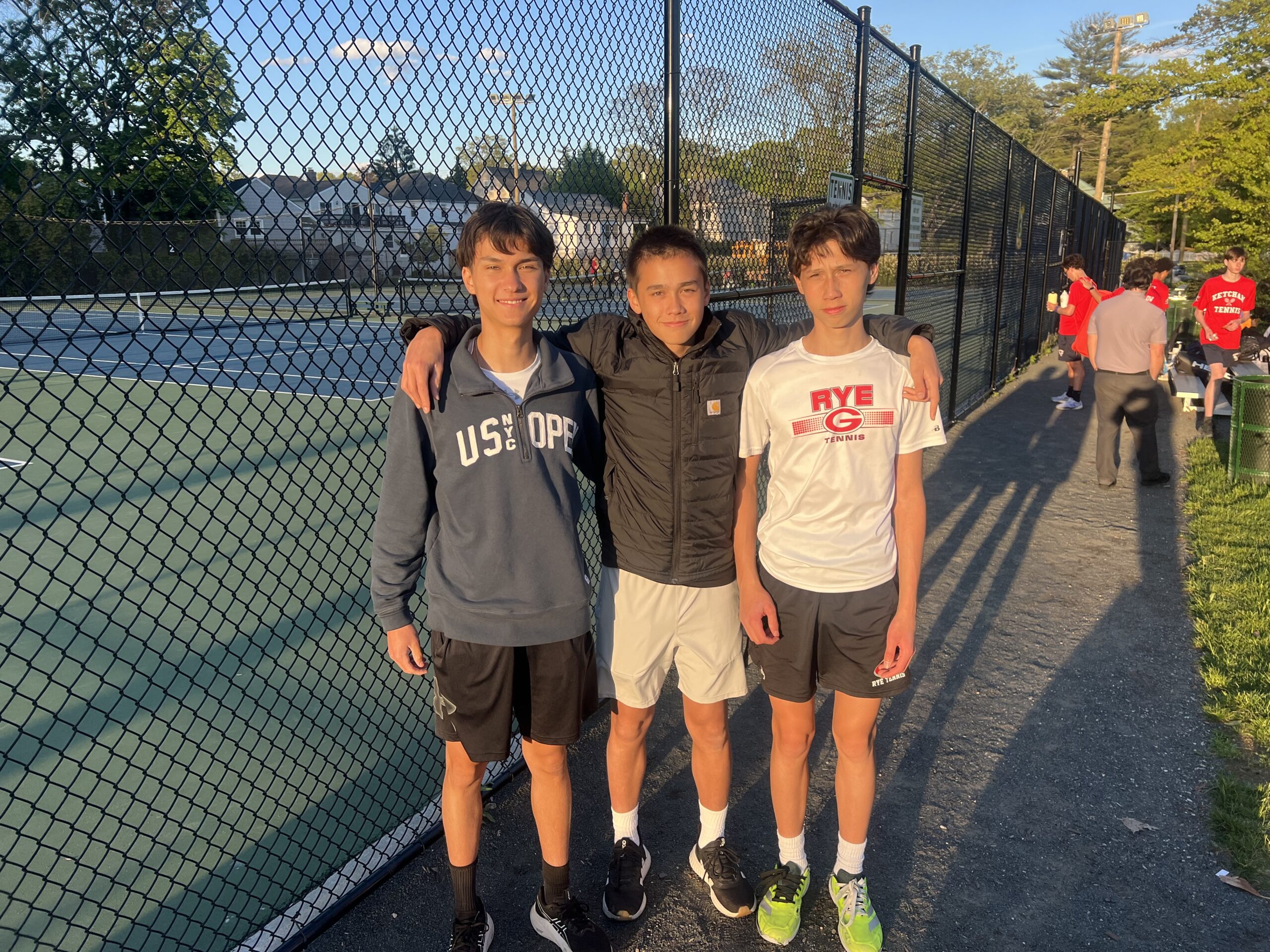 (PHOTO: Luke Gordon (left), Timothy Morell (center), and Xavier Morell (right) from the Rye Boys Tennis team's match on May 7, 2026. Contributed.)