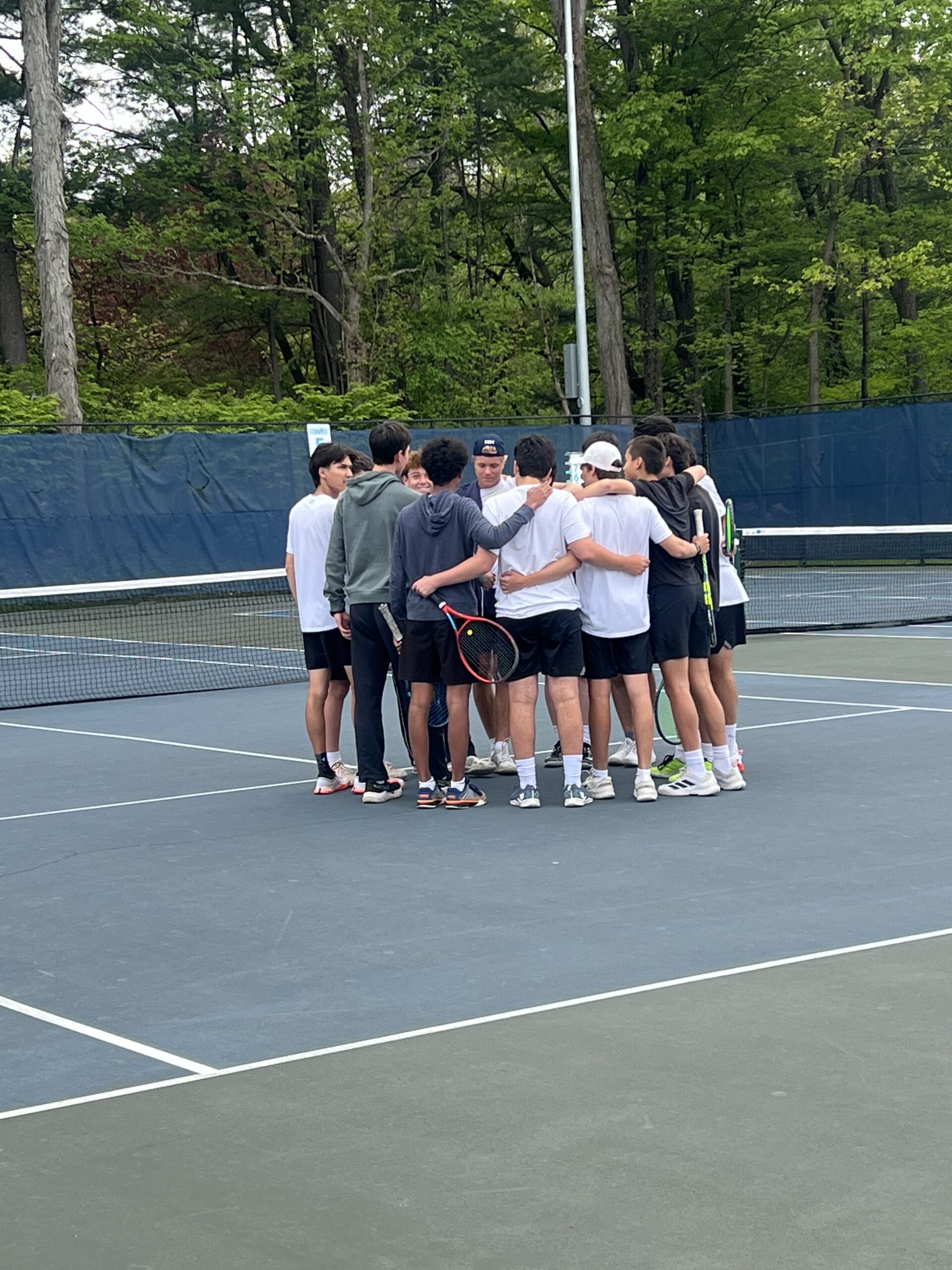 (PHOTO: The Rye Tennis team in a huddle before their match on May 11, 2026. Contributed.)