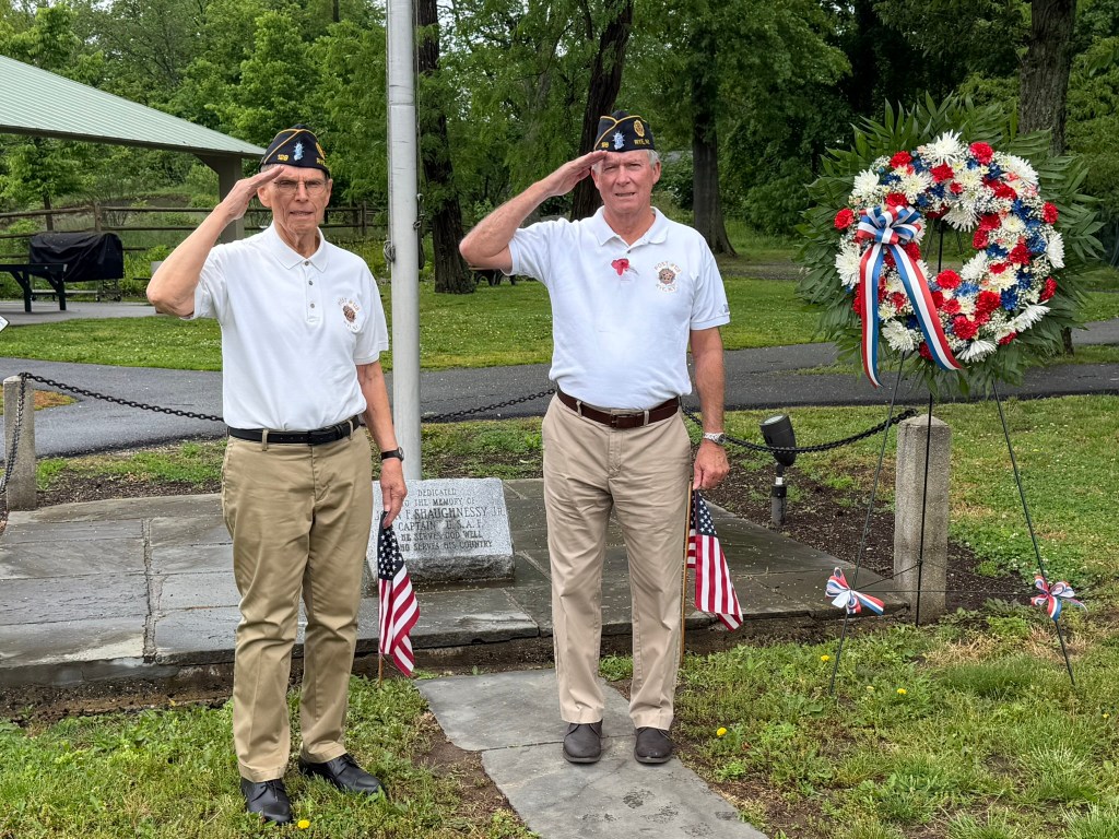 Veterans laying wreath at Memorial.