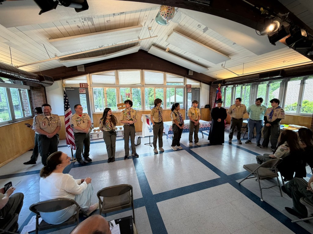 Eagle Scouts lined up in the front of the room.