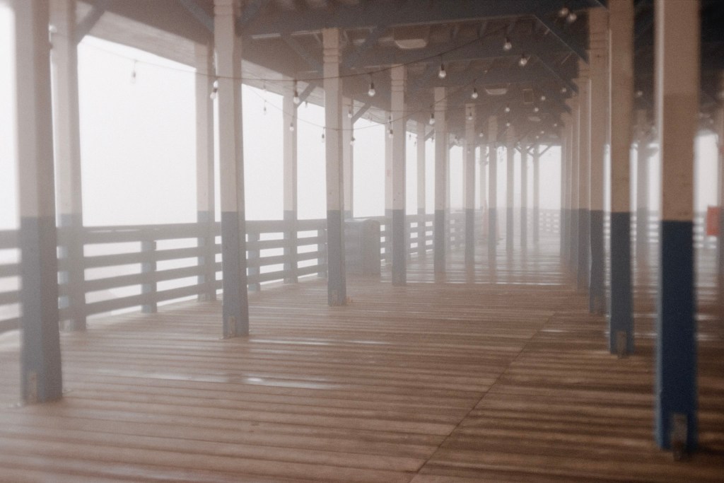 (PHOTO: Playland Pier. The boardwalk at Playland covered by a hazy fog. By Markus Peters.)