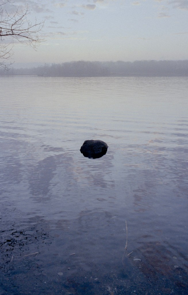 (PHOTO: Misty Harbor. A lone rock visible in the water of Milton Harbor. By Markus Peters.)