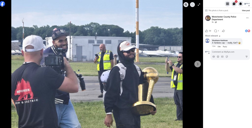 two basketball players walking with trophy