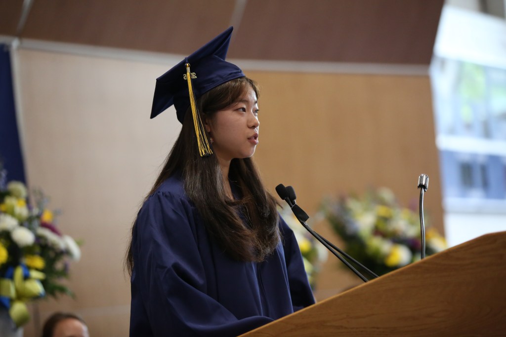 (PHOTO: Senior Class President Selena Zhang spoke to the graduating class of 2026 at Rye Country Day School. Credit: Bruce Gilbert.)