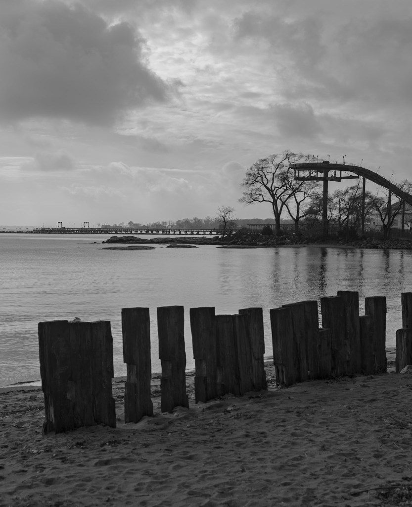 (PHOTO: Along the Shore. A view of a makeshift wall lining the coastline across from Playland Park. By Markus Peters.)