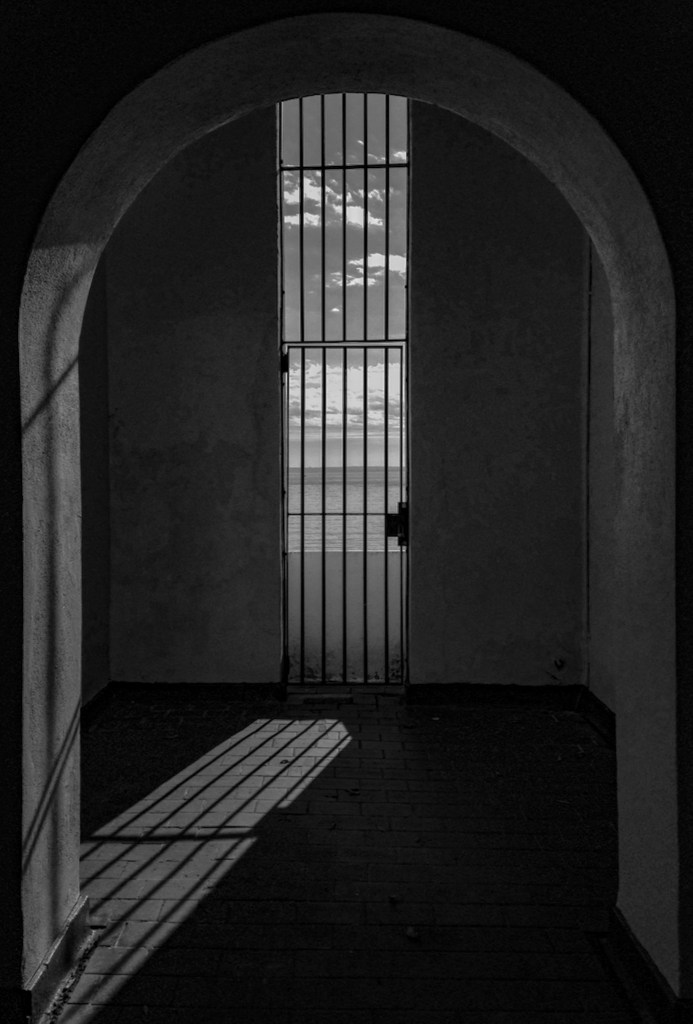(PHOTO: The Light Beyond. The intense shadows in the corridor of the Playland Baths tower are broken by light spilling through the window. By Markus Peters.)