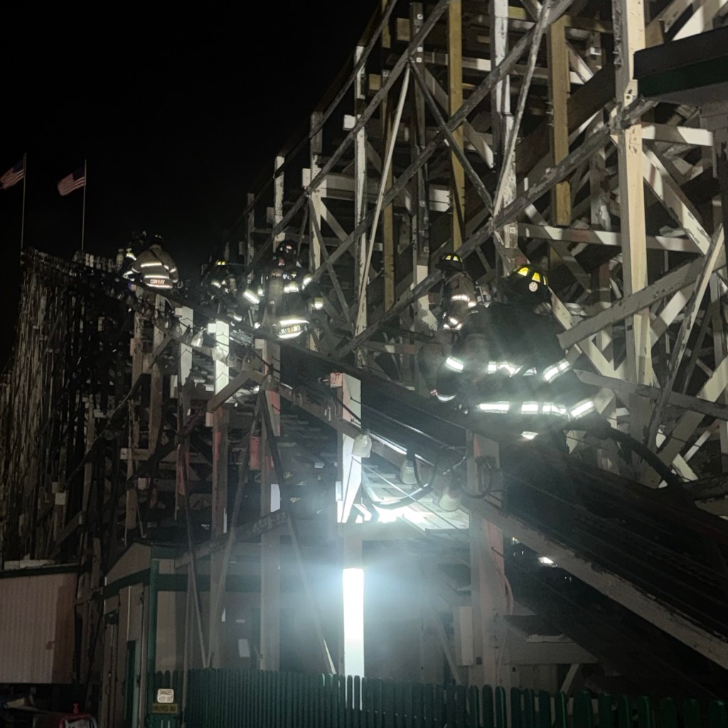 Firefighters climbing on roller coaster structure