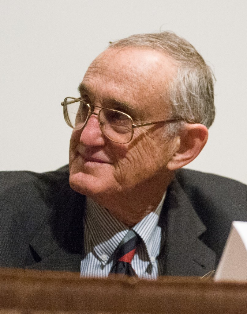 (PHOTO: Nobel Laureate David Morris Lee appears at a conference at Brown University in 2007. Public Domain via Wikimedia.)