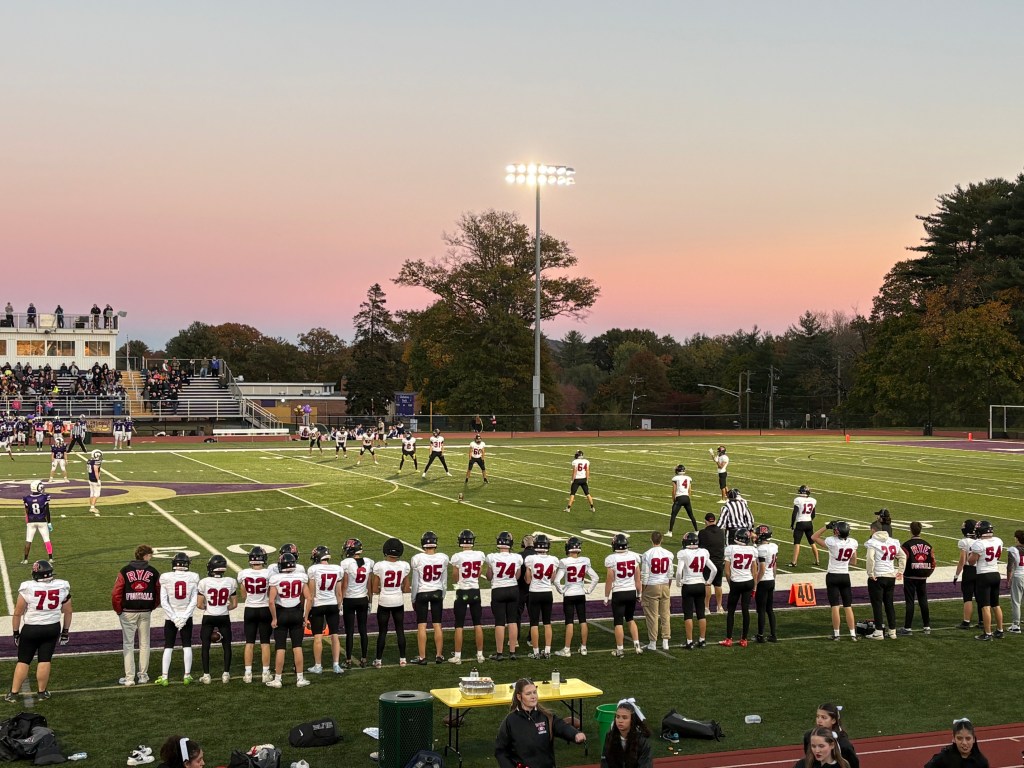 (PHOTO: The Rye Football team set to kick it away against Clarkstown North in front of a beautiful sunset on October 23, 2026. Contributed.)