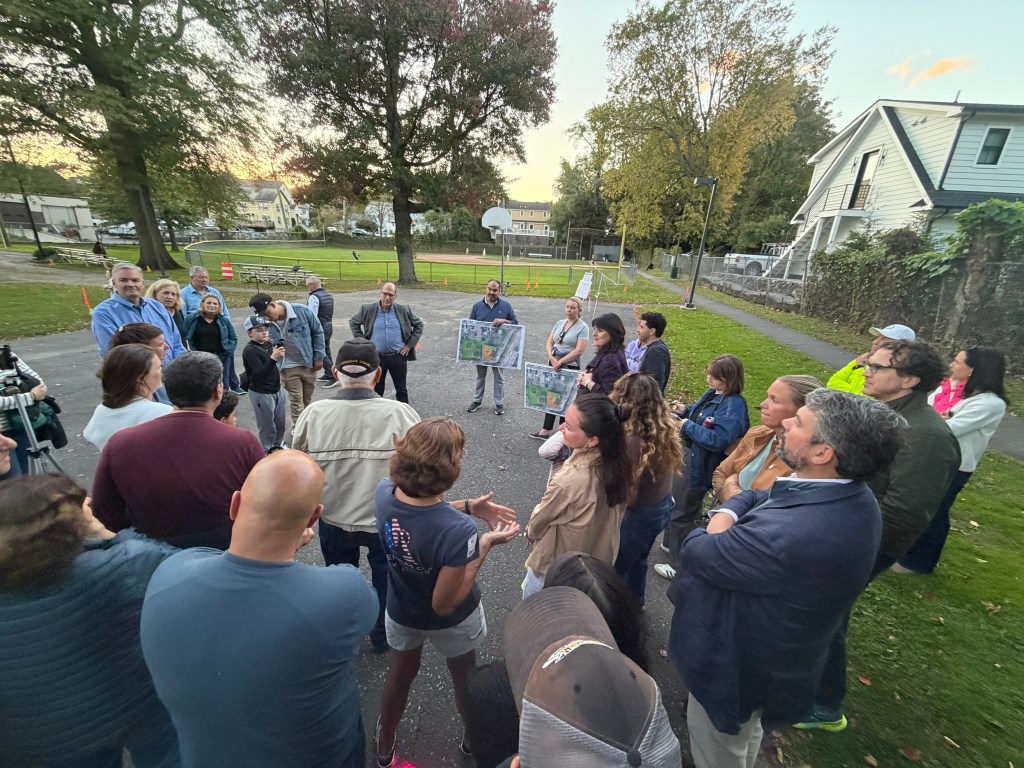 Local residents attending an outdoor public meeting
