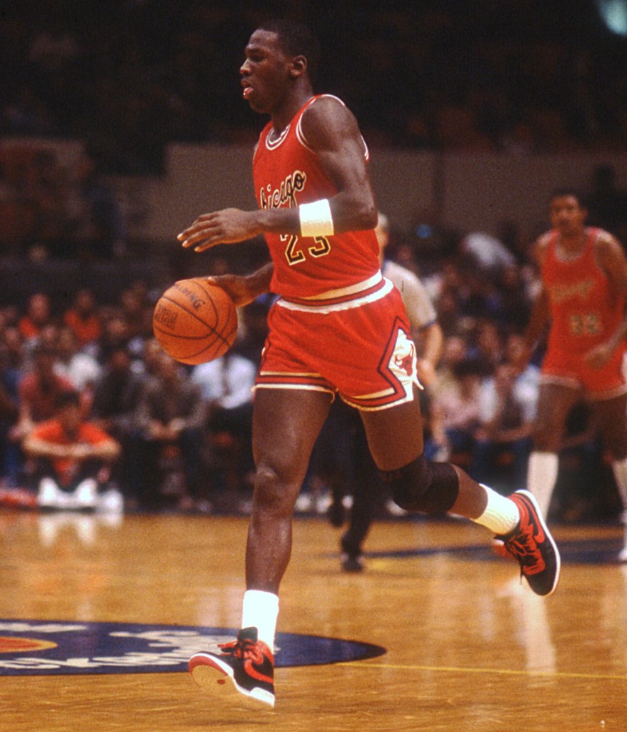 (PHOTO:
Michael Jordan setting the Chicago Bulls offense during one of his first NBA games, an exhibition game in Madison Square Garden against the New York Knicks on October 18, 1984. Credit: Public Domain, Carmine Galasso of North Jersey Media Group.)