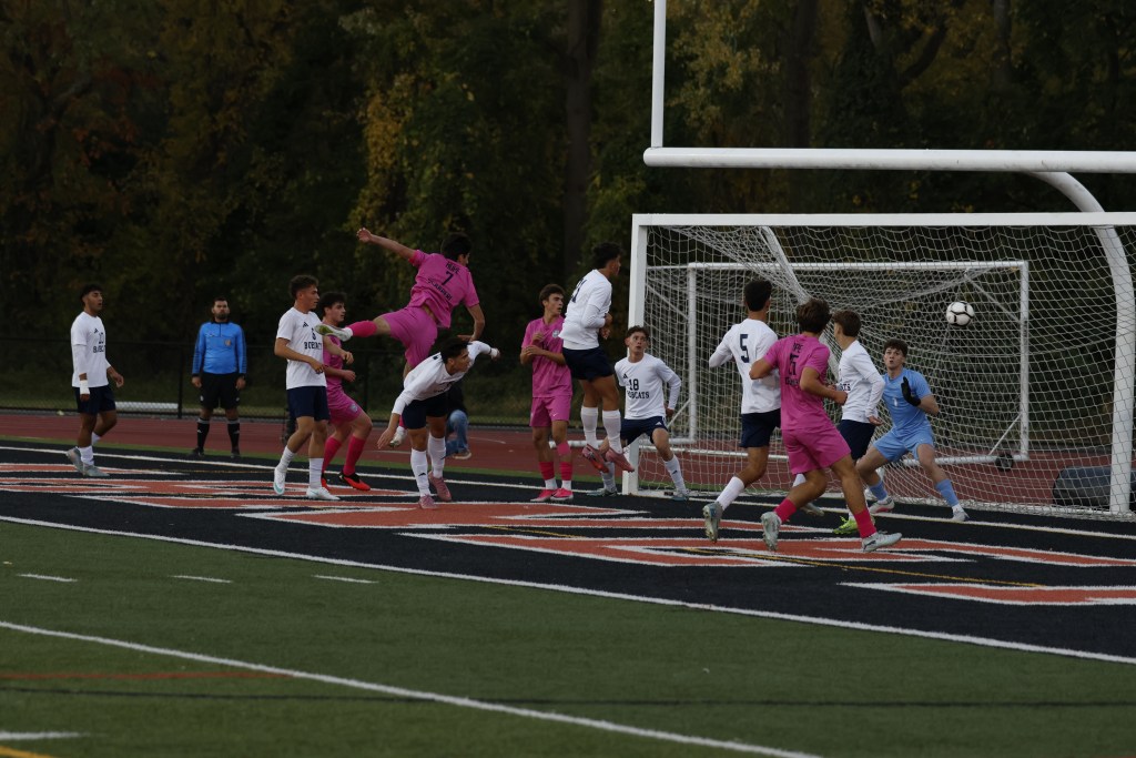 (PHOTO: Rye Boys Soccer's Kasen Scarperi (#7) scoring a header goal on October 26, 2026. Credit: Alvar Lee.)
