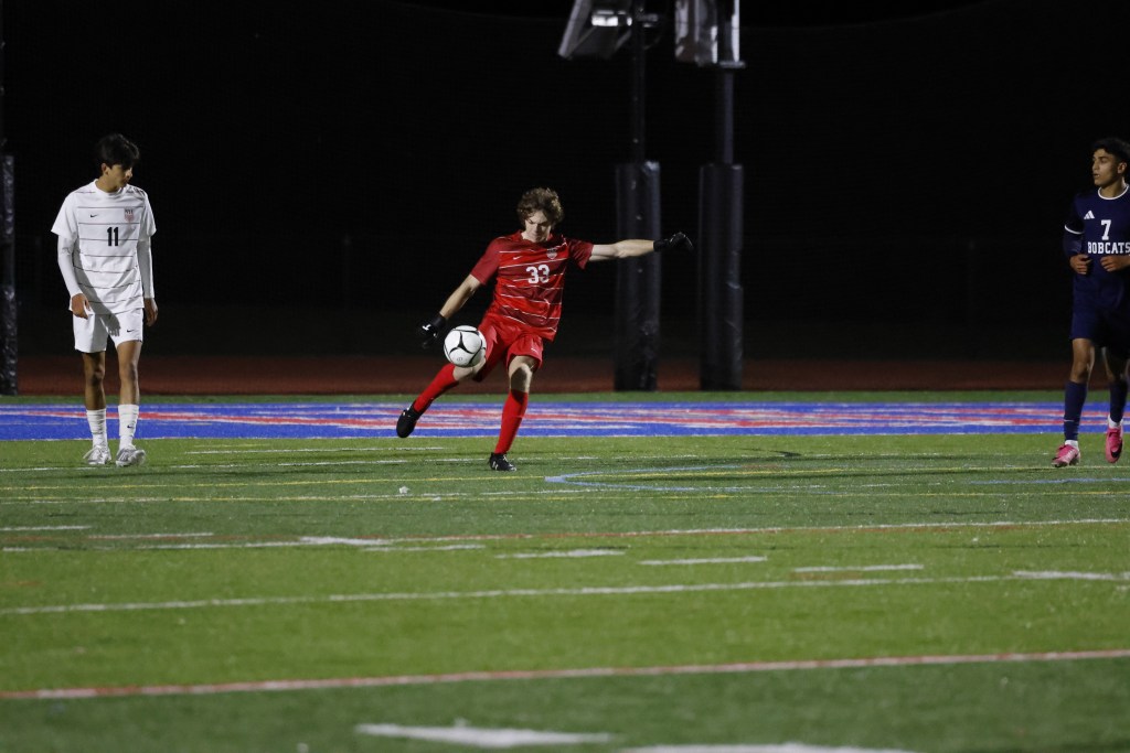 (PHOTO: Rye Boys Soccer's Cole Furber (#11 white) and Will Alexander (#33 red) from a 4-0 win on October 6, 2026. Credit: Alvar Lee.)